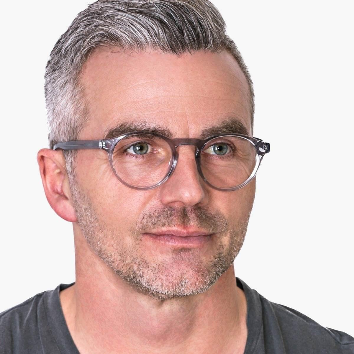 Person wearing round crystal grey reading glasses